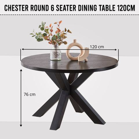 Black round dining table 6 seater styled with dining chairs and place settings